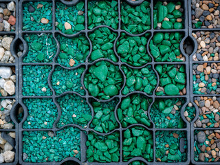 Small Green Painted Stones Under a Metal Square in the Yard