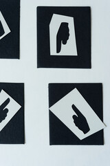 black paper tiles with stencils of pointing fingers