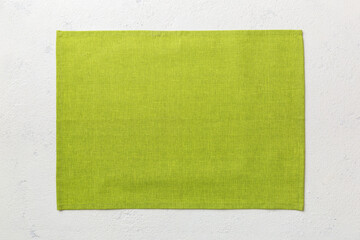 Top view of green tablecloth for food on cement background. Empty space for your design