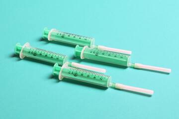 Top view of syringes in a row for medical injection on colorful background with copy space. Health and vaccination concept