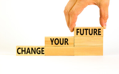 Change your future symbol. Concept words Change your future on wooden blocks on a beautiful white table white background. Businessman hand. Business, financial change your future concept. Copy space.