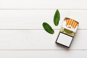 Pack of menthol cigarettes and fresh mint on colored table, Menthol cigarettes top view flat lay