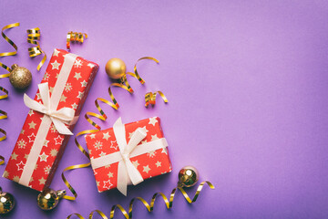 Holiday flat lay with gift boxes wrapped in colorful paper and tied decorated with confetti on colored background. Christmas, Birthday, Valentine and sale concept, top view