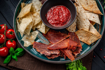 Various types of dried meat with spicy sauce.