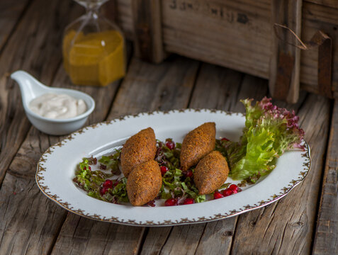 kebbah served in a dish isolated on wooden background side view of appetizer