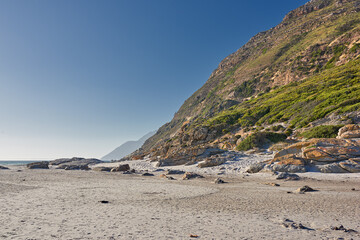 Fototapeta na wymiar Copyspace landscape view of the rocky coast of Western Cape in South Africa. Beautiful scenery on the seashore at the beach during summer in a popular tourist city. Natural environment of the ocean