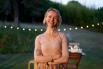 Portrait of a Scandinavian blonde middle-aged woman looking at the camera. Smiling nordic female in...