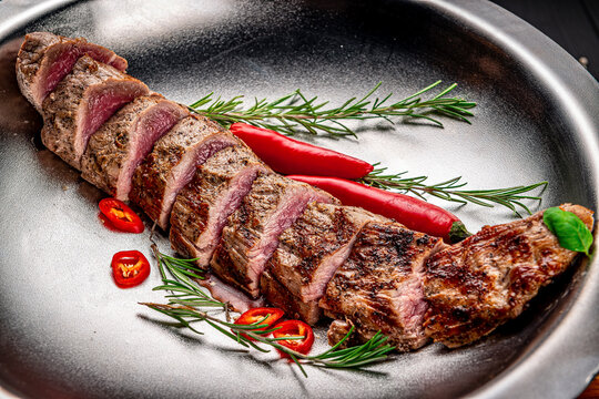 Grilled veal tenderloin. Juicy steak medium rare beef with spices