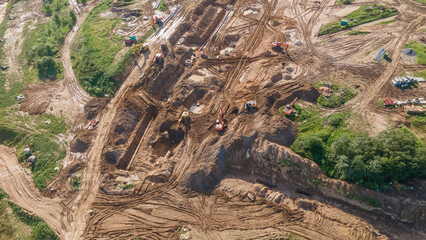 Aerial view of excavators on earthwork at construction site. Earthworks during the install of storm sewers. Sanitary sewer.