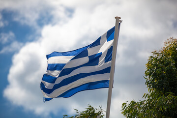 Greek flag on cloudy windy day, Greece