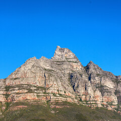 Fototapeta na wymiar A scenic landscape view of Table Mountain in Cape Town, South Africa against a blue sky background from below. A panoramic view of an iconic landmark and famous travel destination with copyspace