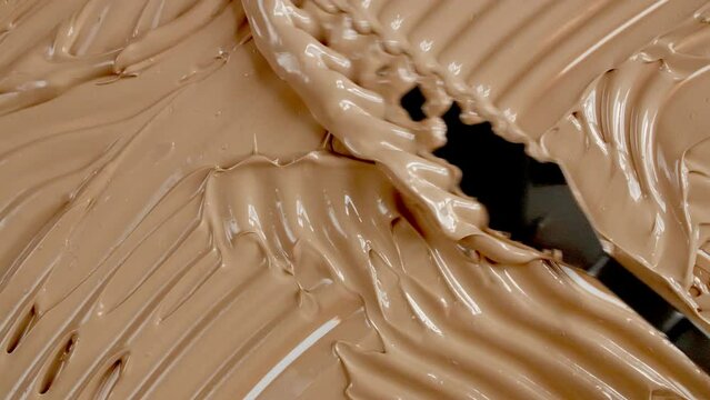 Foundation for face, smear, concealer, cosmetic liquid foundation, or cream beige color smudge. Beauty skincare sample. Macro Shot. High quality 4k footage