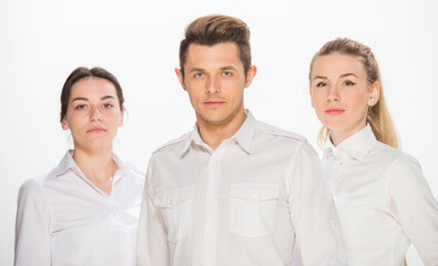 team of young business people in white shirts on a white background isolated. a team of two girls and a guy is happy, wins, plans, argues, discusses, gets upset, wins something. close-up portrait 