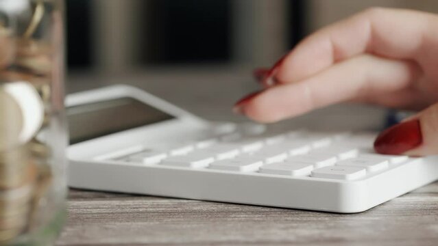 A woman is calculating her expenses for a month. Coins for taxes or payments. Concept of poverty savings money or counting budget and unemployment. Close up