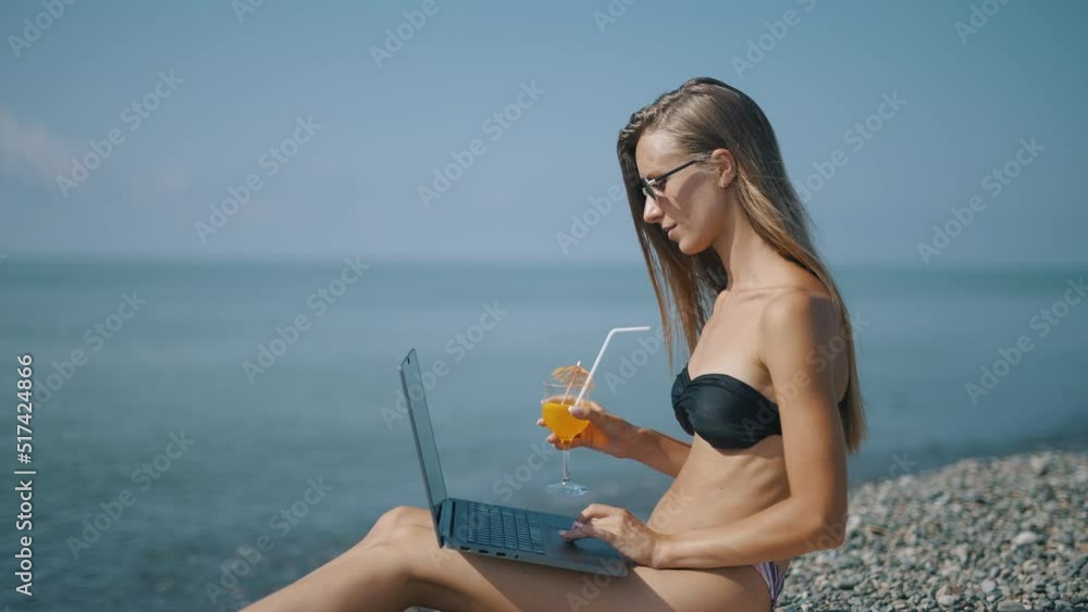 Poster a female freelancer is working on laptop near sea. programmer is coding and surfing on notebook. rem