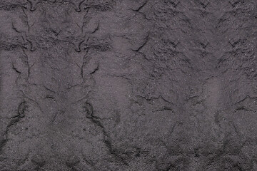 Navy blue background of natural slate. Texture of stone closeup. Graphite backdrop macro