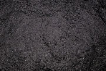 Dark gray background from natural slate. Texture of stone closeup. Graphite background macro