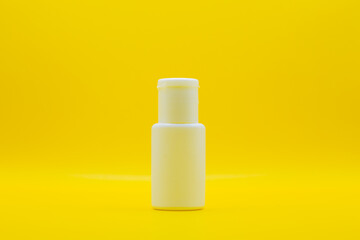 Used cosmetic cream , It is decorated and placed on a yellow screen.