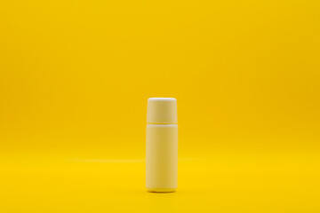 Used cosmetic cream , It is decorated and placed on a yellow screen.