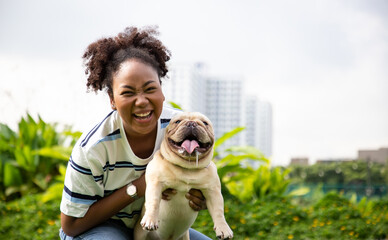 Bulldog with owner spend a day at the park playing and having fun on grass in the garden. Animals and people on allergy season concept
