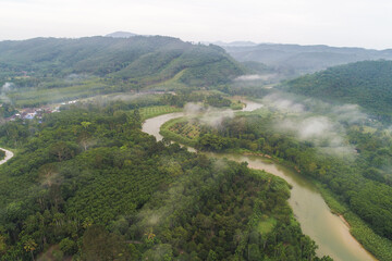 Fototapeta premium Aerial view canal river in tropical rainforest with morning fog