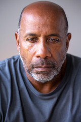 Portrait of a mature man looking sad and away from the camera.