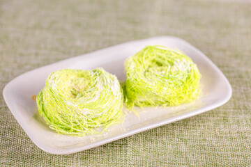 Green pulled sugar or bird nest or Dragon Beard candy. Also known as Semang in Malaysia.