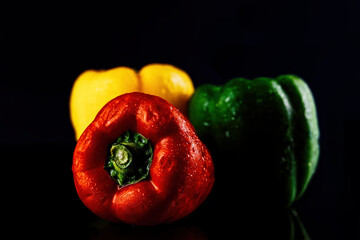 Colorful bell peppers on a dark background