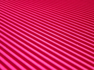 Background surface made of red, crimson pape rwith diagonal stripes