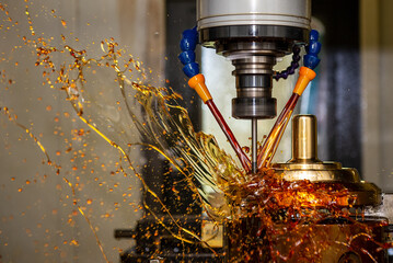 The splash of oil coolant on CNC milling machine.