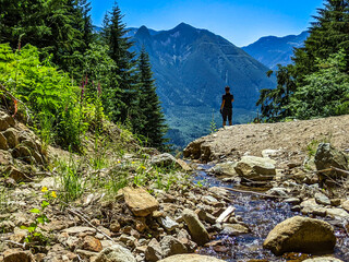 Mountain Biker taking a break near a creek in the Pacific Northwest. 