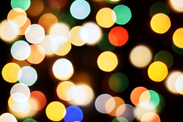 Fototapeta premium multicolored festive lights on a black background screensaver backdrop