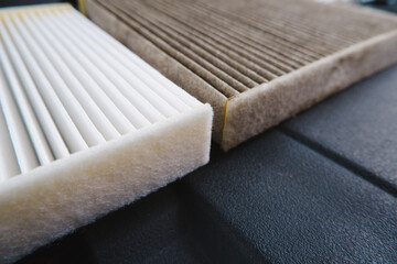 Close up side macro of new car air filter and old dirty air filter,selective focus on side