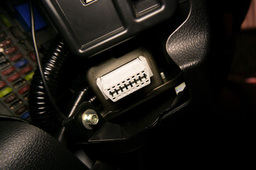 OBD2 port for vehicle electronic diagnostic under the car dashboard