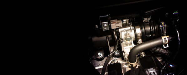 Close up of  throttle body of engine drive system in a car with horizontal copy space on black background