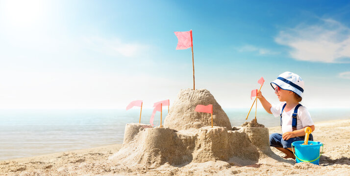 Kid Play On The Seashore On A Hot Sunny Day. Little Girl On The Beach Building A Sand Castle On Summer Vacation.