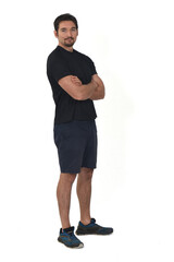 view of man wearing sportswear, shorts and looking at camera and arms crossed isolated on white background