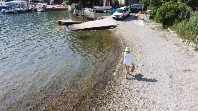 Woman walking into old Roman ruins in Palace, Mljet island
