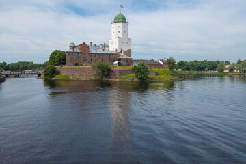 View of the ancient Vyborg castle from the Northern harbor on a July afternoon. Leningrad region, Russia