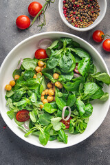 salad chickpeas, legumes, lettuce, mache, tomato fresh healthy meal food snack diet on the table copy space food background rustic top view keto or paleo diet veggie vegan or vegetarian food