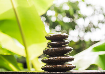 Stack pyramid stone zen pebbles nature on wooden with blur green nater outdoor. meditation tranquil...