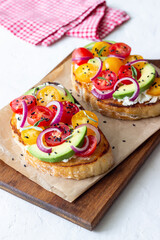 Bruschetta with avocado, tomatoes, onions and white cheese. Vegetarian food. Sandwich. Italian food.
