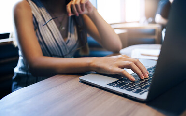 Close up view, young asian woman using laptop computer to working or meeting online with her business group, During a day feman relaxing and use her laptop shopping online