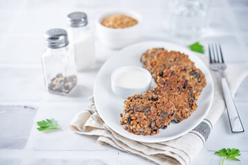 Buckwheat mushroom fritters in a plate with sauce