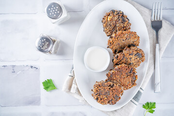 Buckwheat mushroom fritters in a plate with sauce