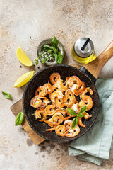 Spicy garlic chili Shrimps boiled shrimps and herbs, prawns in a frying pan with lemon. Seafood, shellfish. View from above.