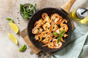 Spicy garlic chili Shrimps boiled shrimps and herbs, prawns in a frying pan with lemon. Seafood, shellfish. View from above.