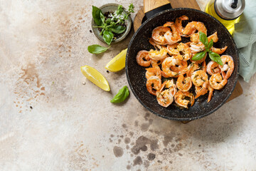 Spicy garlic chili Shrimps boiled shrimps and herbs, prawns in a frying pan with lemon. Seafood, shellfish. View from above. Copy space.