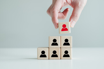 Hand hold red people icon on block. Human resources management and recruitment business hiring...