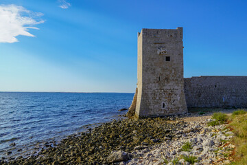 Fototapeta na wymiar An old stone tower on the beach, in Croatia. 